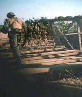Surveying remnants of a bridge damaged by enemy attack